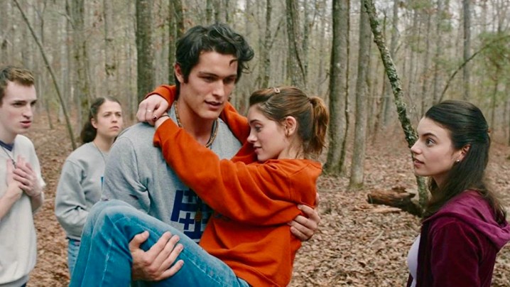 A guy carrying a young girl through the woods in the movie Yes God Yes