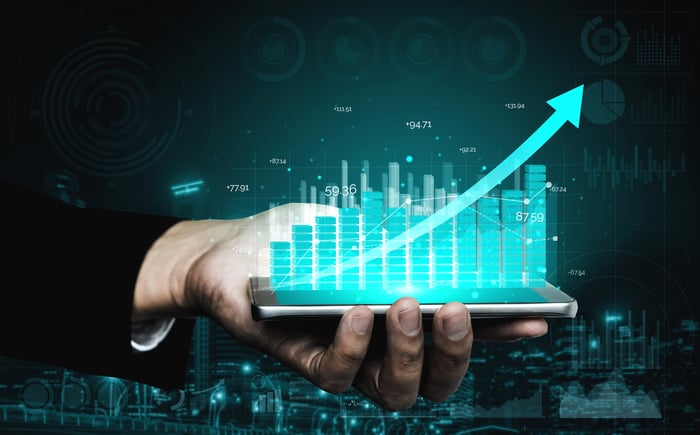 Holographic stock chart held in a person's hand.