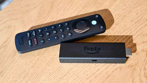 Amazon Alexa Voice Remote Pro sitting next to an Amazon Fire Stick