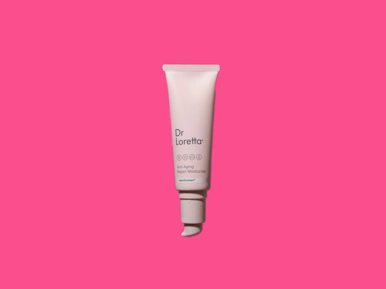 A pink bottle of moisturizer on a pink background