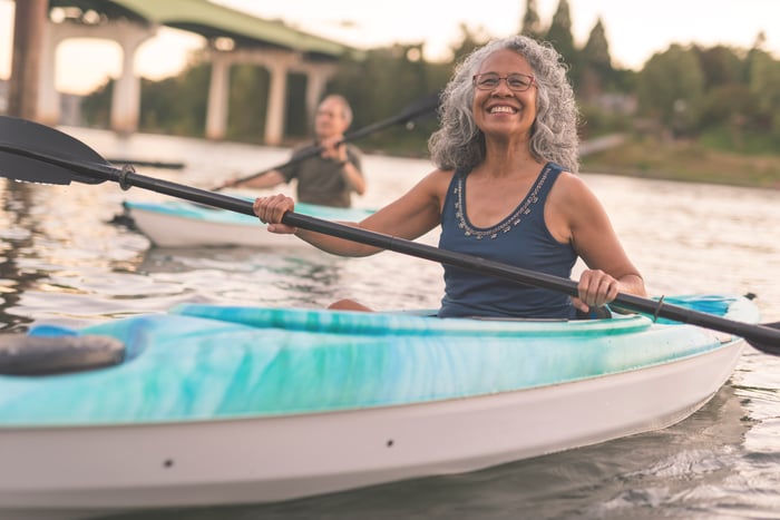 Two people kayaking in a body of water.