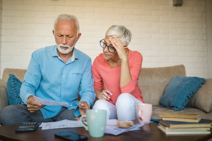 Stressed couple looking at documents.