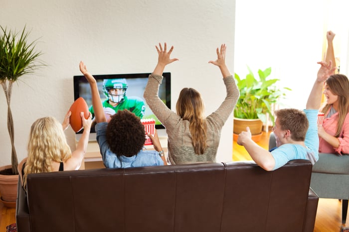 Group of people watching football.