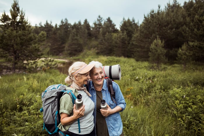 Two adults taking a selfie in a field.