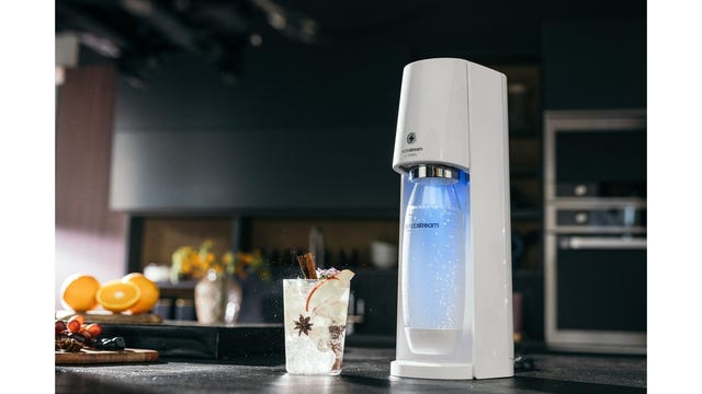 sodastream e terra on table with glass of soda water