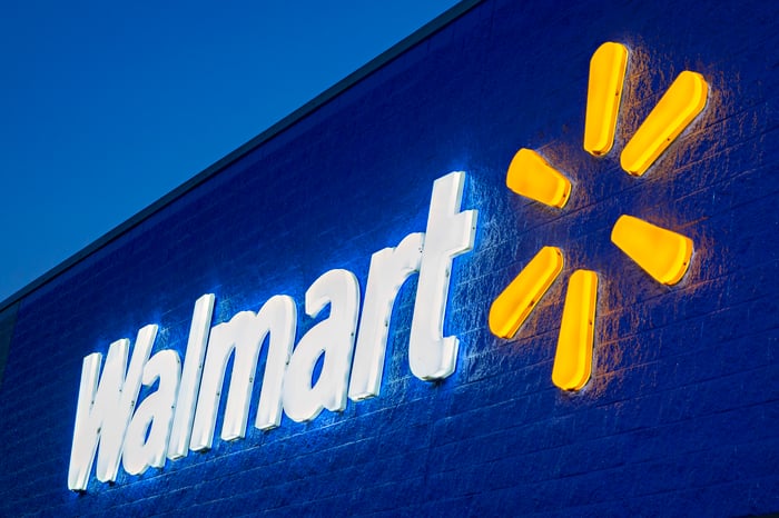 A Walmart sign lit up at night.