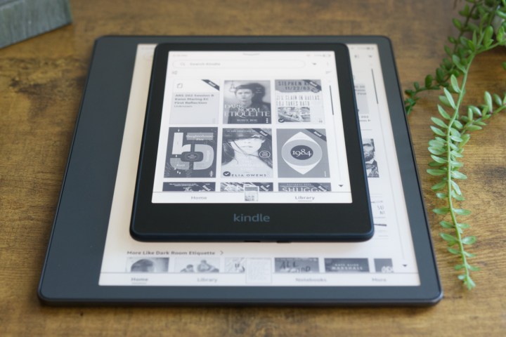 Amazon Kindle Paperwhite sitting on top of a Kindle Scribe.