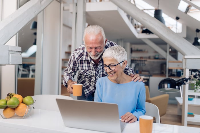 A couple looking at a computer together.