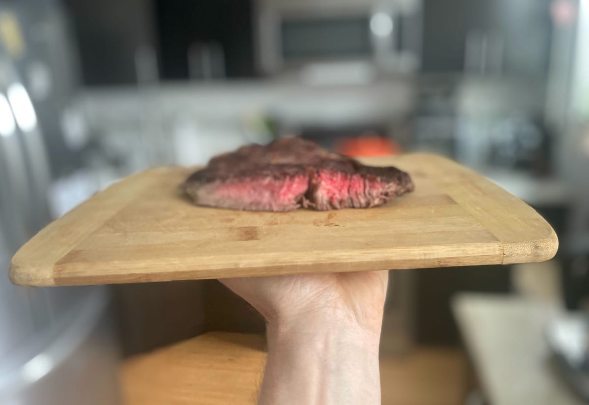 Medium rare steak on cutting board