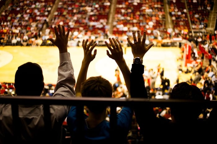 Spectators inside a basketball arena.