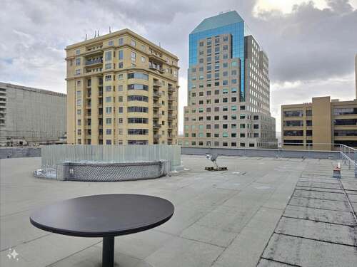 A rooftop with a cafe table