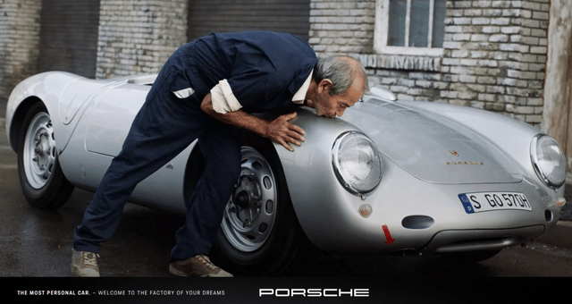 Man kissing a Porsche car