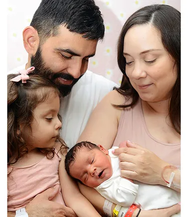 Jorge and Monica Cantu with daughters Amelia, 3, and newborn Lianna. / Photo credit: Mom365