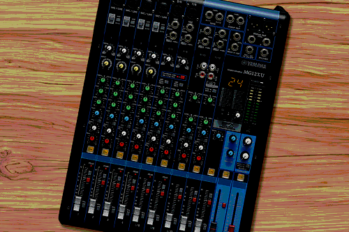 A Yamaha mixer on a wooden surface.