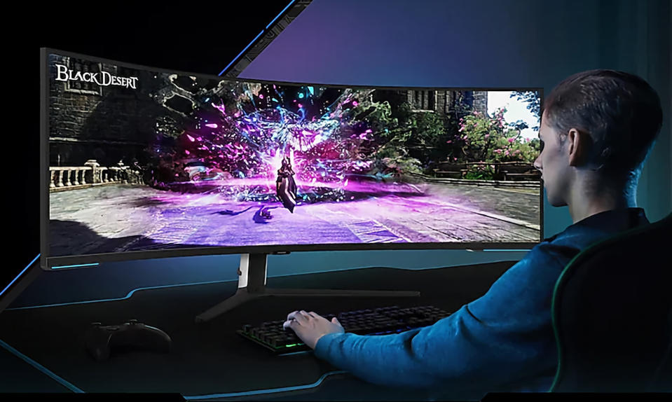 Product lifestyle shot of a young adult playing a game on the ultra-wide Samsung monitor.