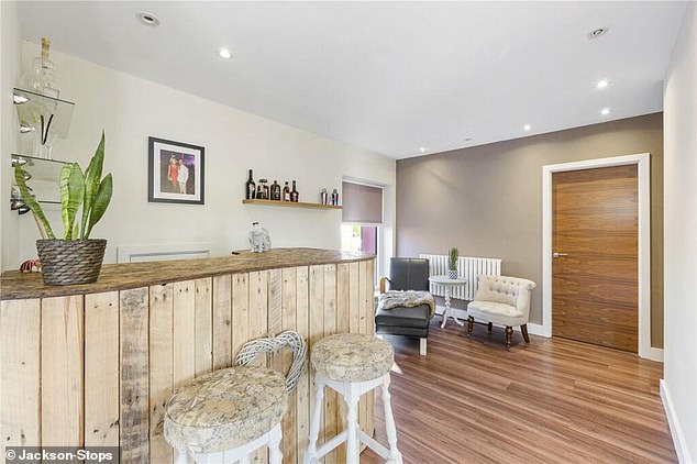 There is an attractive bar at the property, with several bar stools as well as a chaise longue