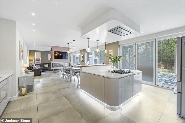 The large living has a modern kitchen with separate island and a large dining space