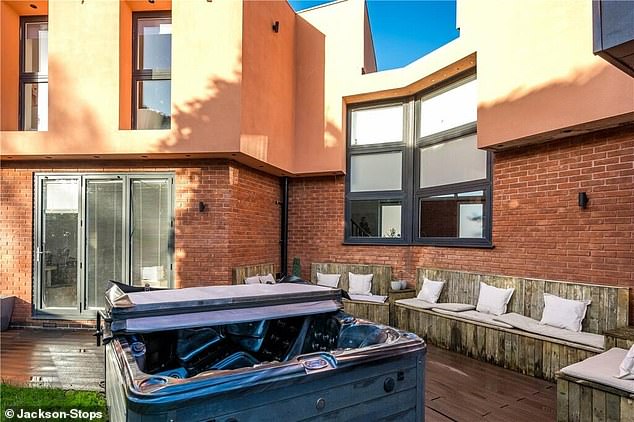 Outside, in the rear garden, there is space for plenty of seating area as well as a hot tub