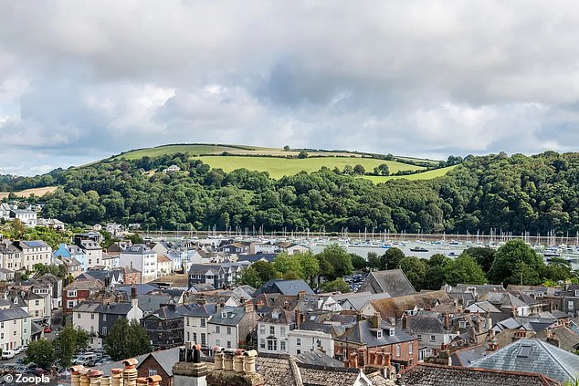 The property's elevated position provides views down to the town's harbour and across the water to the fields and woodlands beyond.