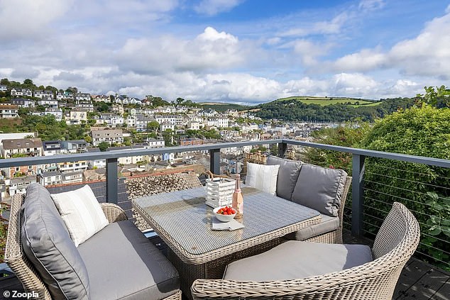 The townhouse has a pretty terrace with space for a dining area and far-reaching views