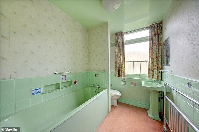 There are three bathrooms in the property, including this one with a light green bathroom suite