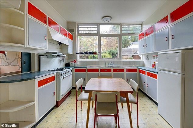 The property's kitchen features retro stacking chairs and formica red and grey kitchen units