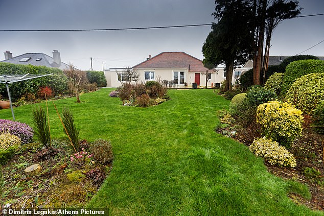 Workload: The Steeles, who live just outside Haverfordwest in Pembrokeshire, are looking to downsize to a property with a more manageable garden than their current home (pictured)