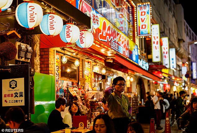 Slump: A line of bars and restaurants in a busy Tokyo shopping district.  Japan has lost its spot as the world's third-biggest economy to Germany