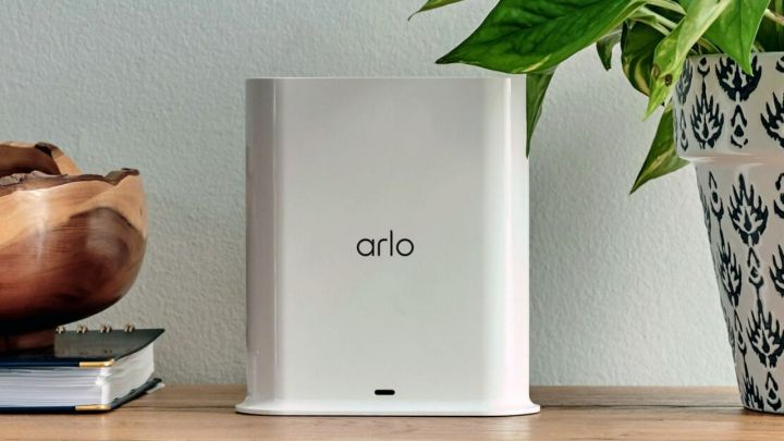 An Arlo Smart Hub on a wooden table.