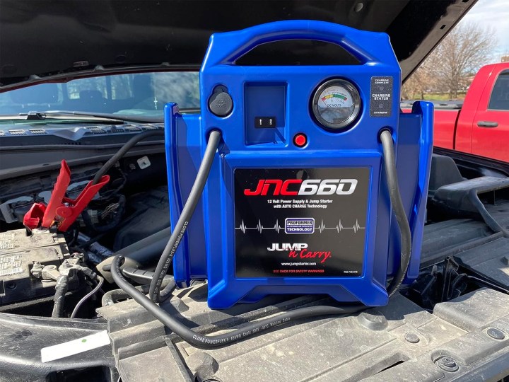 The Clore Jump-N-Carry JNC660 portable jump starter connected to a truck battery.