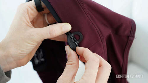 A Garmin HRM Fit user highlights how to attach the device's clip to a sports bra.