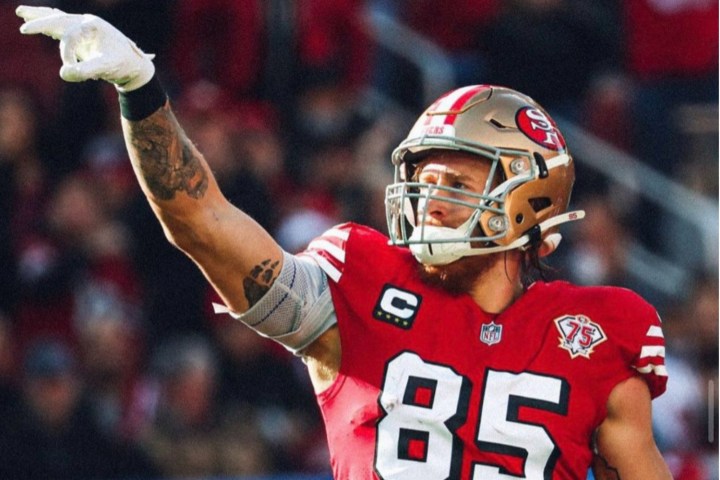 George Kittle of the San Francsico 49ers points his fingers up.