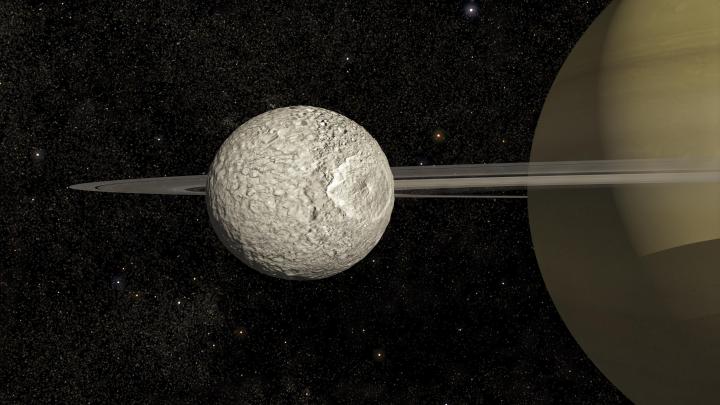 An illustration of Mimas orbiting Saturn.