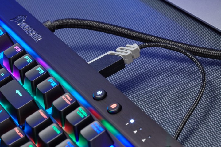 A USB cable connected to the Corsair K70 LUX RGB keyboard.