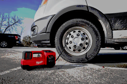 Milwaukee M18 Inflator connected to a van tire.