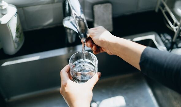 Person using a water tap at home