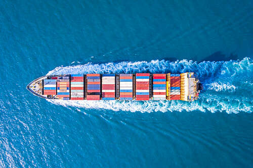 Aerial view of container ship in sea.