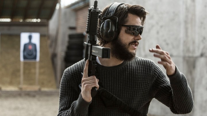 A man holds a gun in American Assassin.