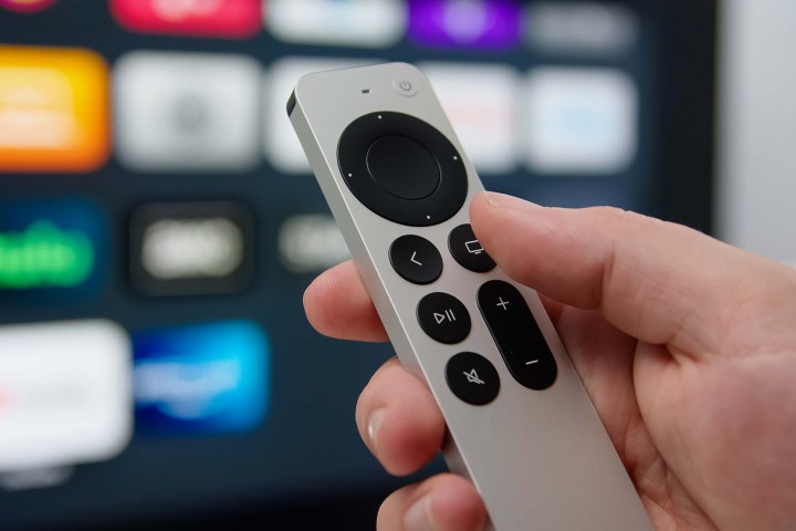 The Siri Remote in someone's hand.