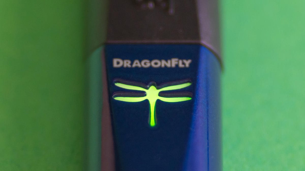 An AudioQuest DragonFly Cobalt glowing green.