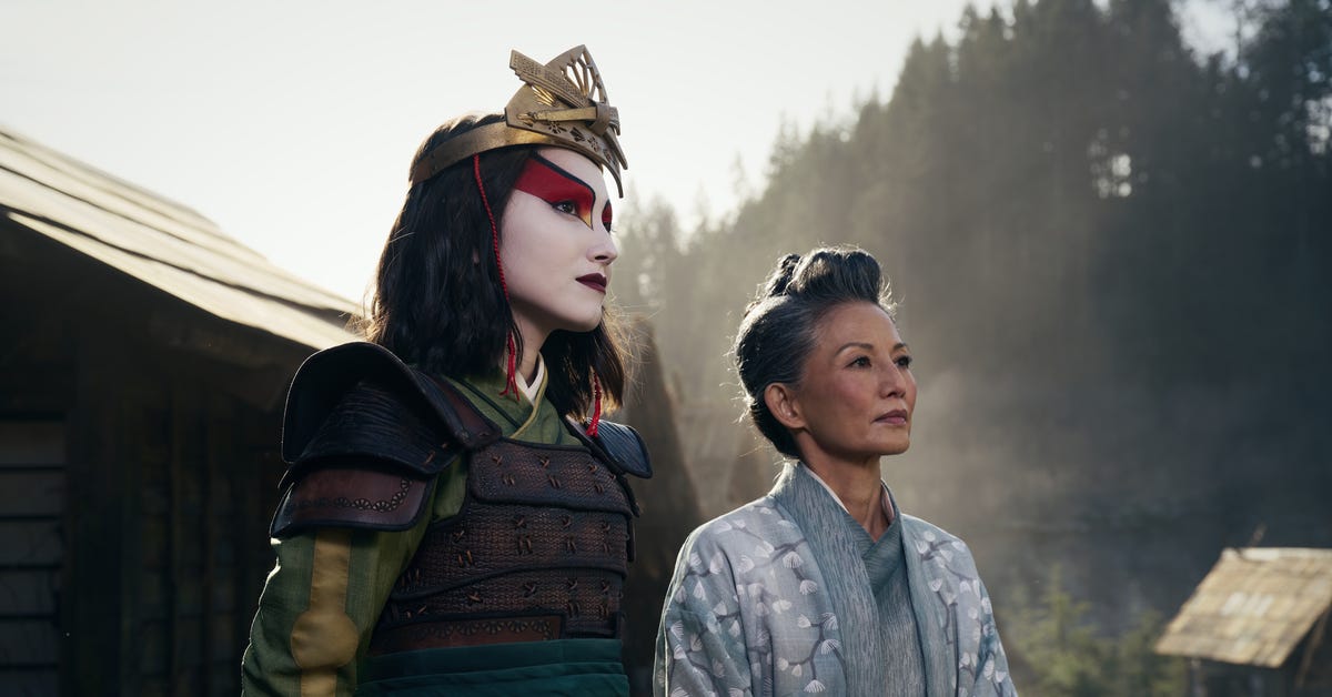 a warrior woman stands outside next to woman