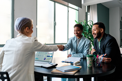 Businesswoman closing a deal with clients