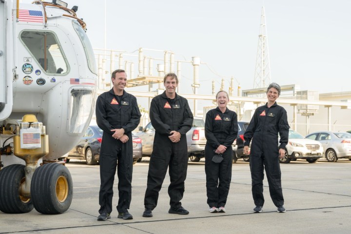 The CHAPEA mission 1 crew (from left: Nathan Jones, Ross Brockwell, Kelly Haston, Anca Selariu) exit a prototype of a pressurized rover and make their way to the CHAPEA facility ahead of their entry into the habitat on June 25, 2023. 