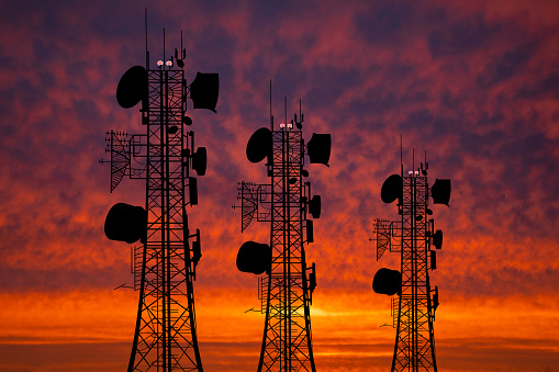 Communication tower against the background of the sunset sky. Communication concept