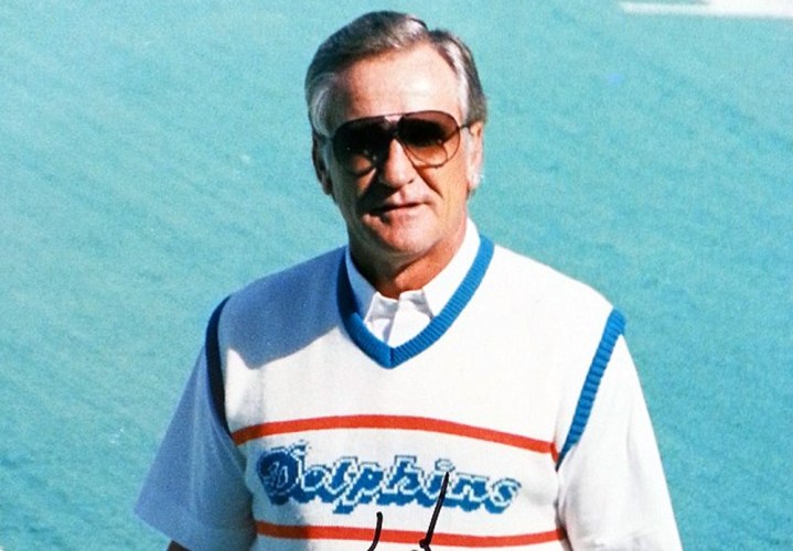 Don Shula wears sunglasses on the football field.