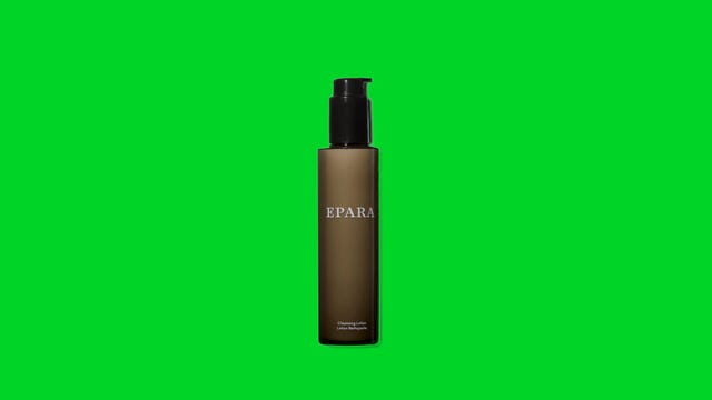 A bottle of black cleansing lotion on a green background