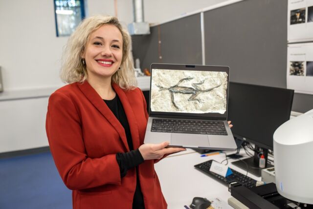 Valentina Rossi with an image of <em>Tridentinosaurus antiquus</em>.