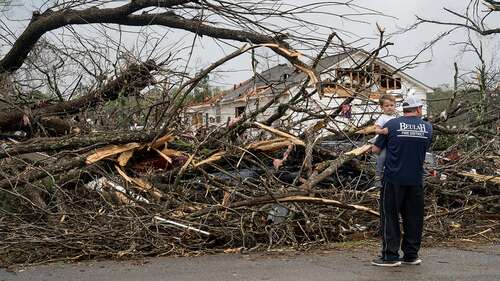 A family surveys damage from a Tornado in Georgia