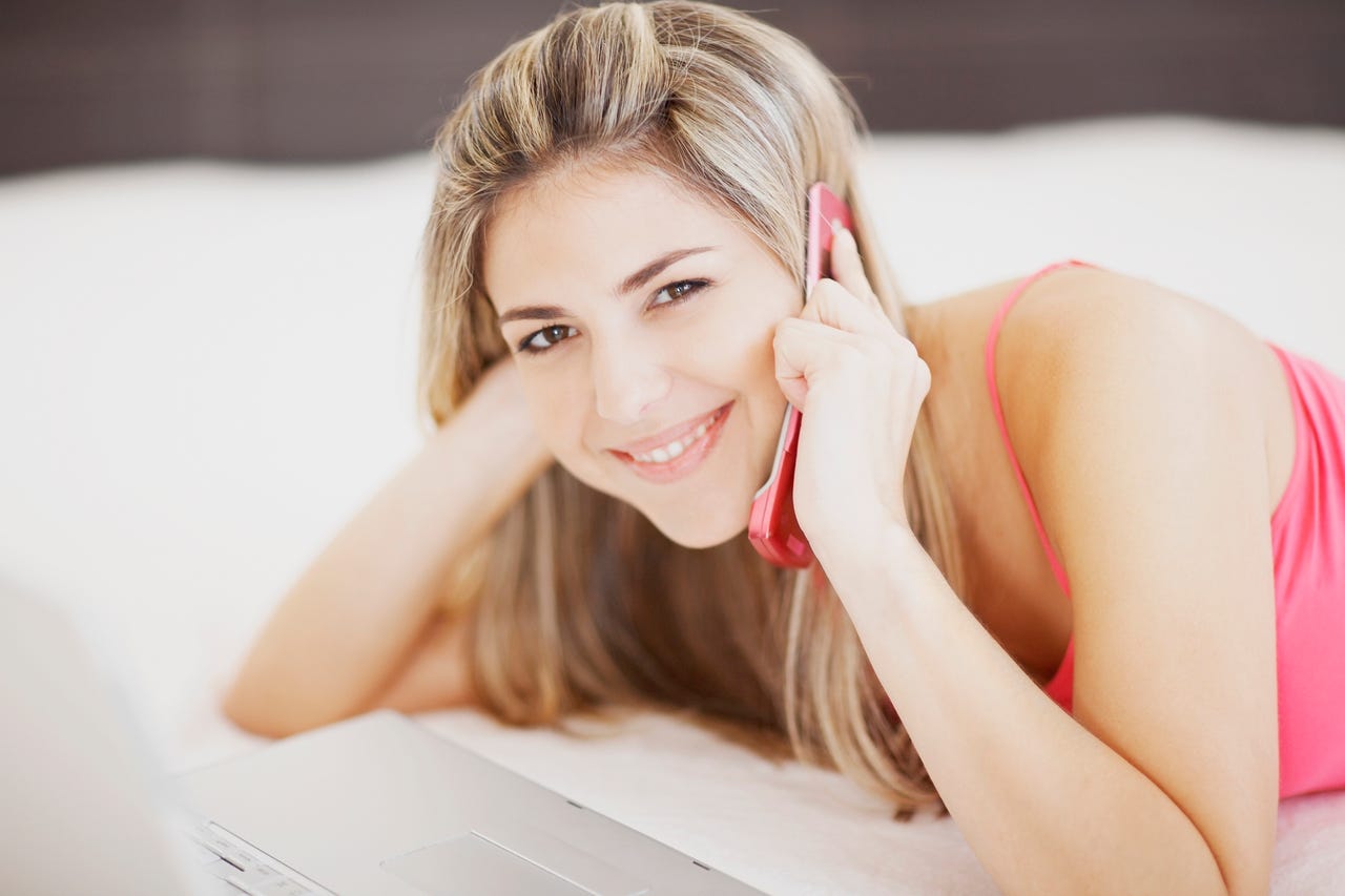 woman using pink flip phone