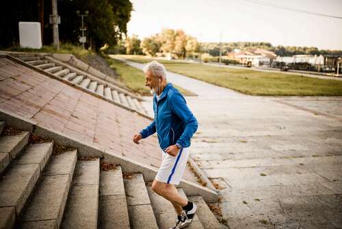 A person runs up a set of stairs outside